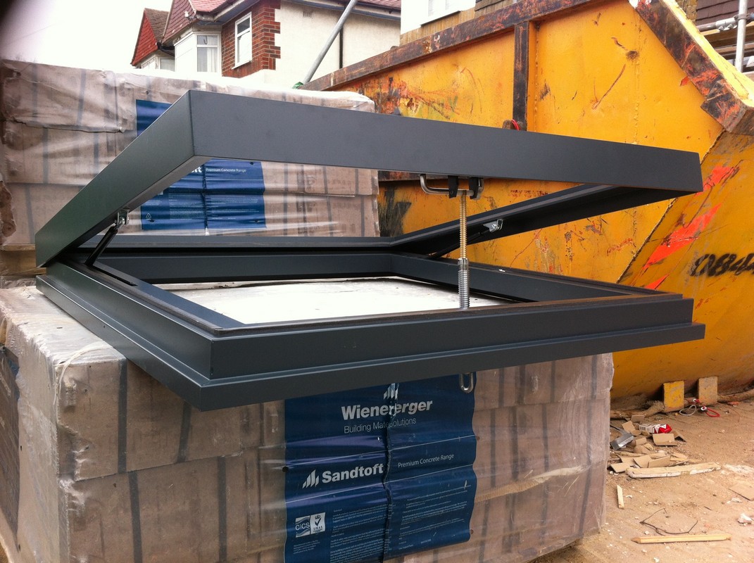 Opening flat roof skylight in anthracite grey installed in Wolverton